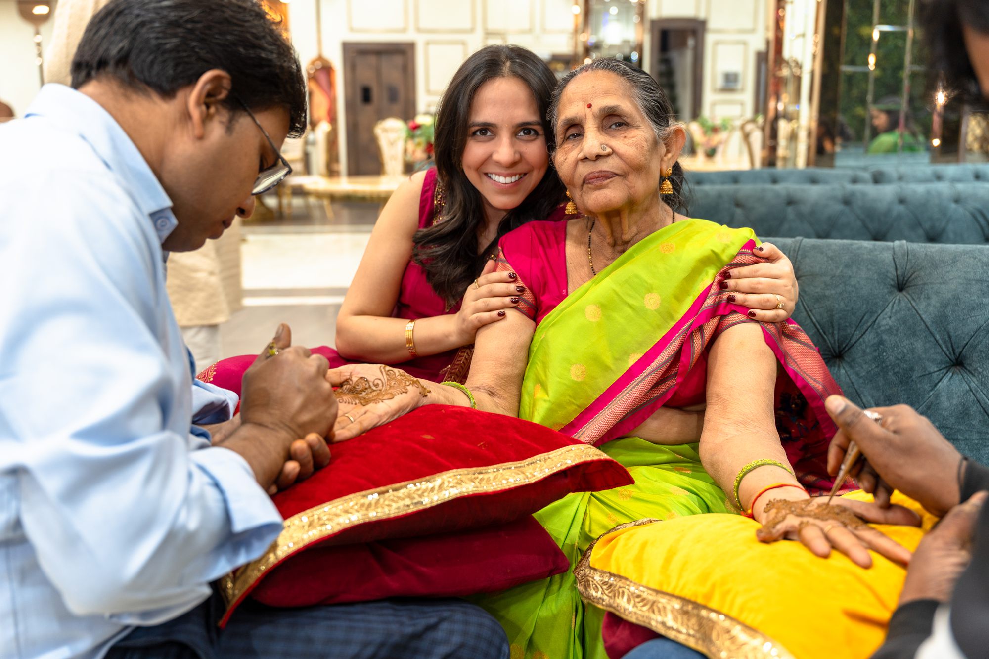 Mehendi being applied at a family gathering