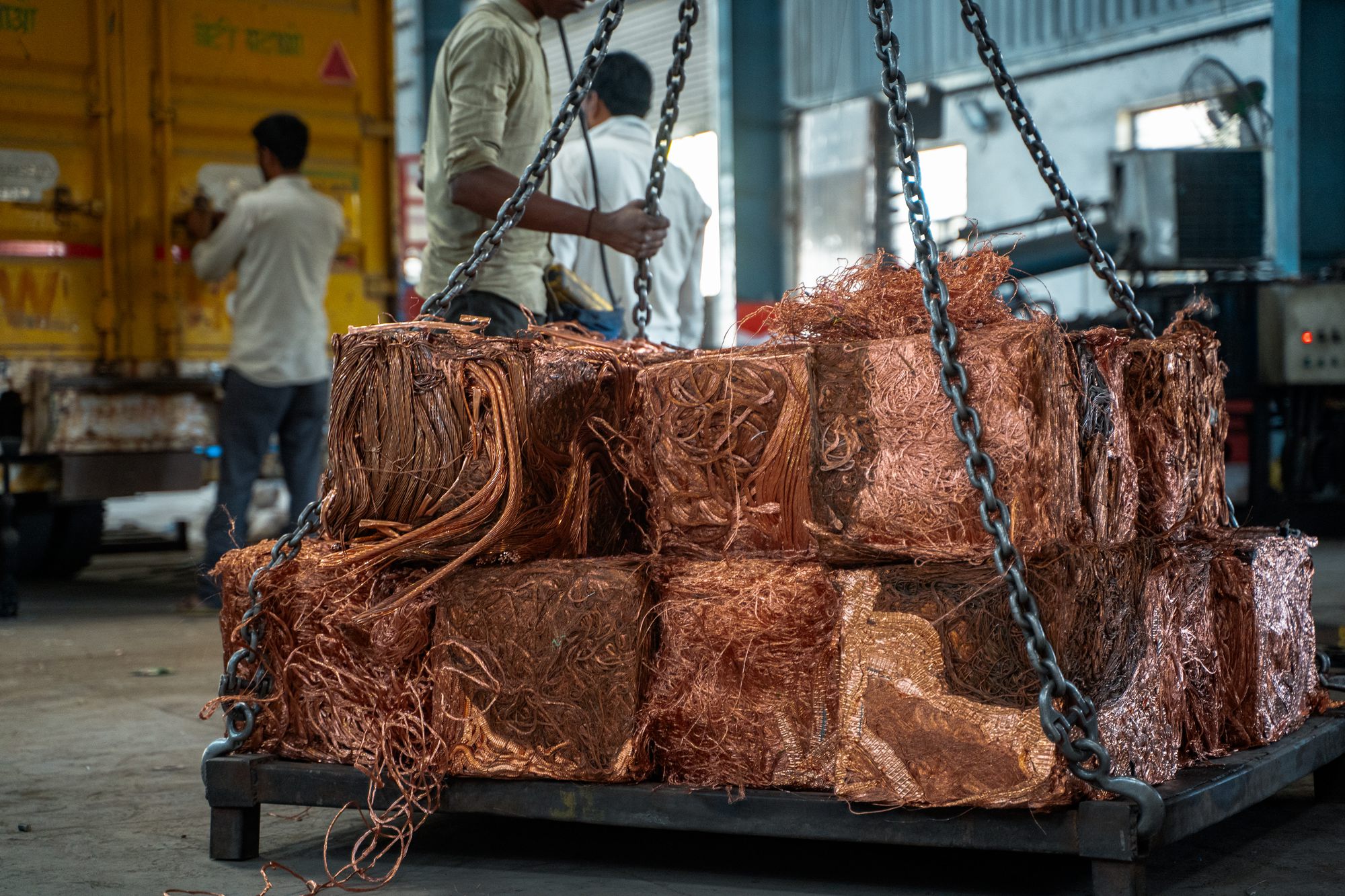 Bales of copper scrap lifted by an overhead crane